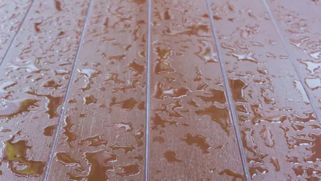 Water droplets on a wood plank floor